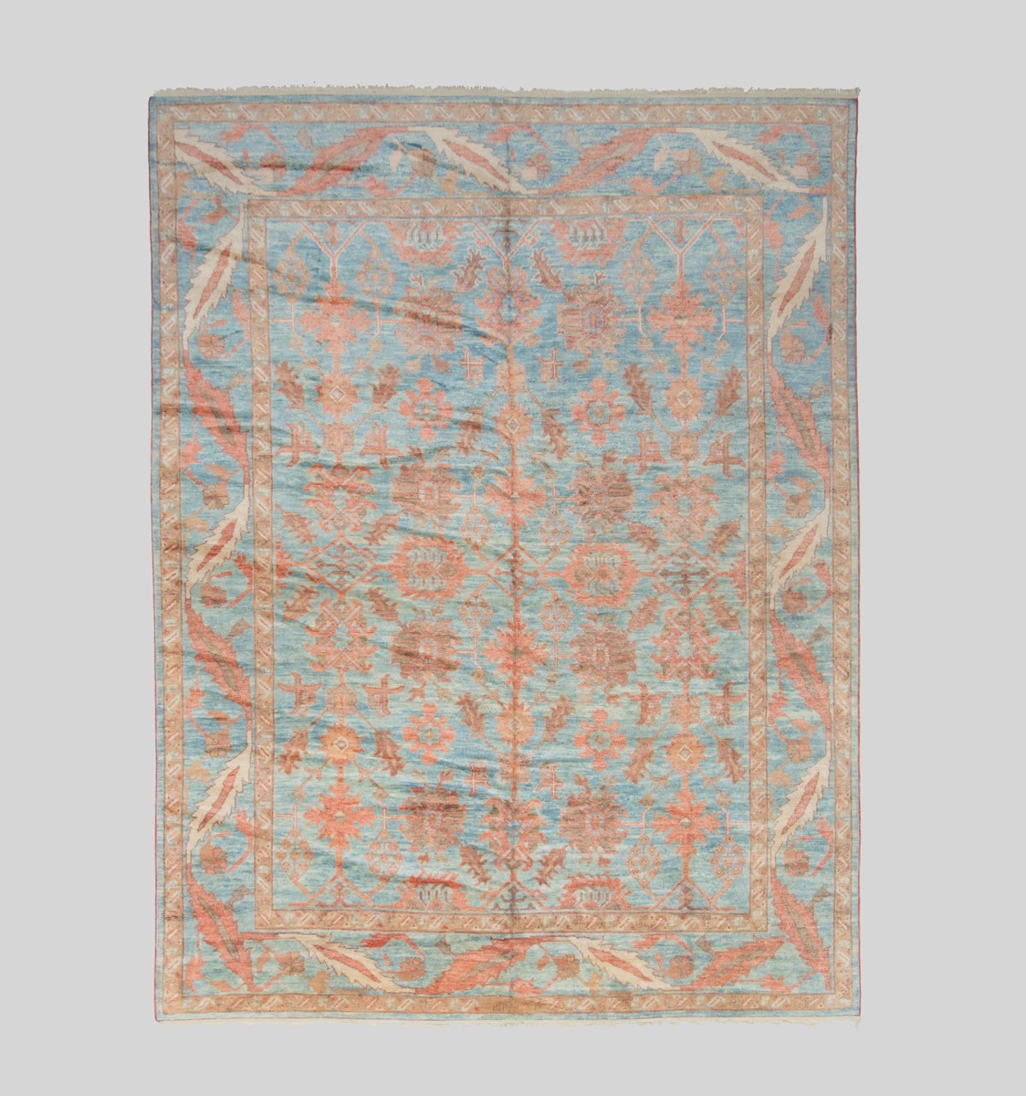 A dark coral and blue ground Oushak carpet, Circa 1960 Robert Kime